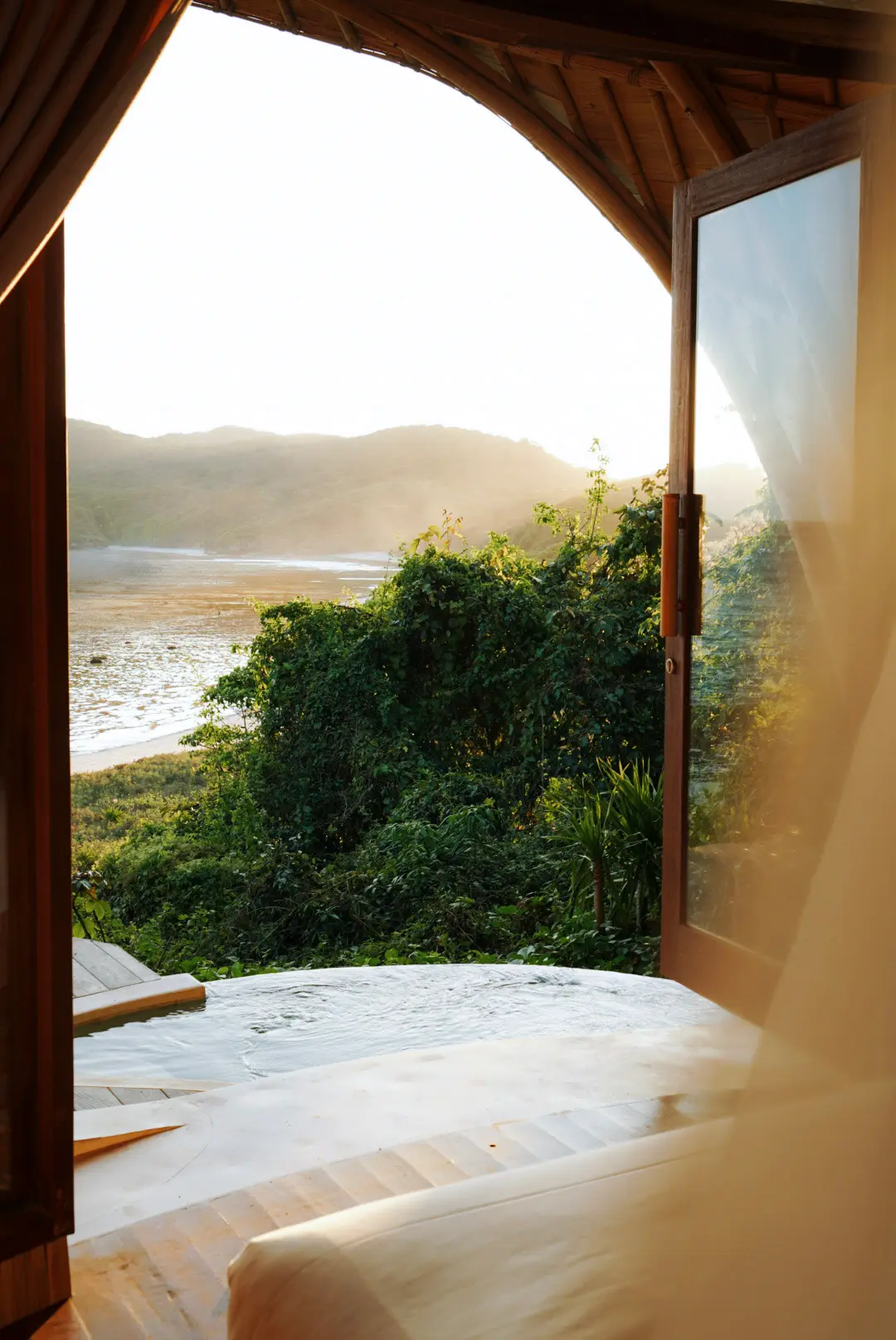 Handcrafted bamboo Beach View lodge exterior surrounded by tropical jungle — Kini Resort Sumbawa